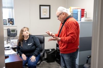 Man and Woman speaking in Barton Brands of Maine Office